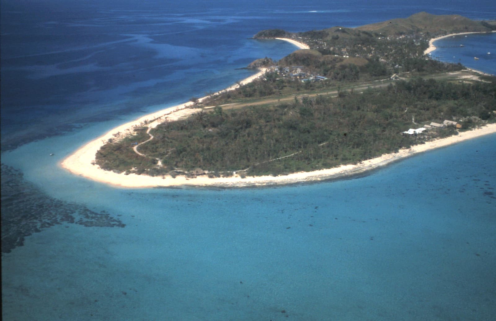 Aerial view of Mana Island showing its long white sandspit and turquoise lagoon