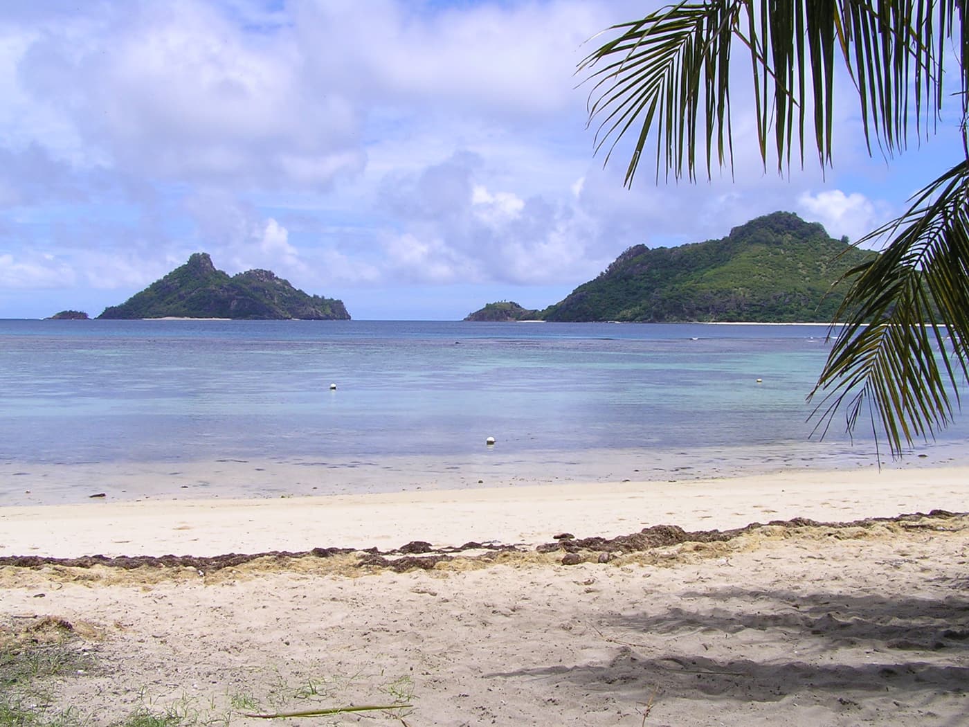 A quiet Mamanuca beach with rocky islets offshore