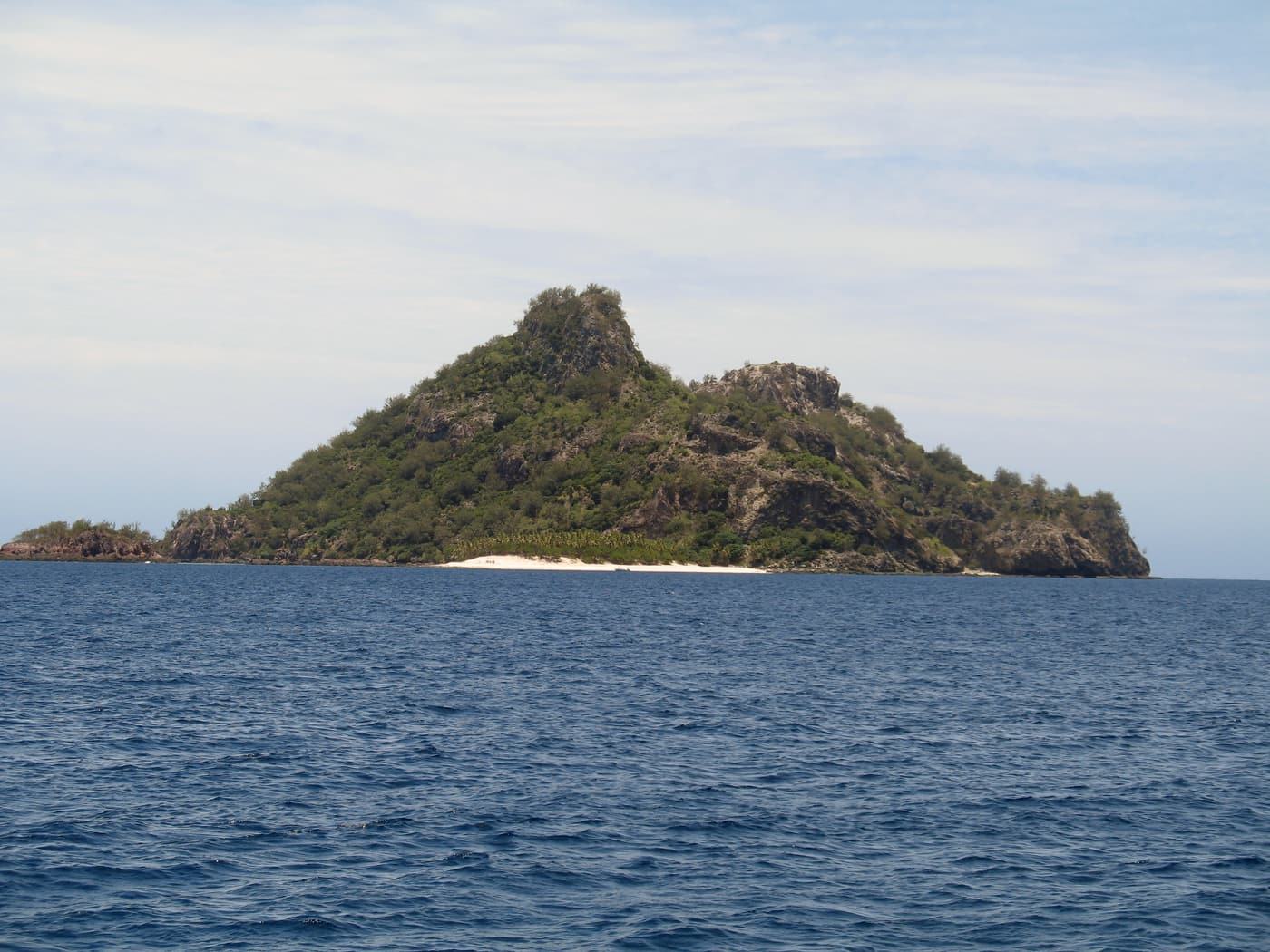 The jagged volcanic outline of Monuriki seen from a boat