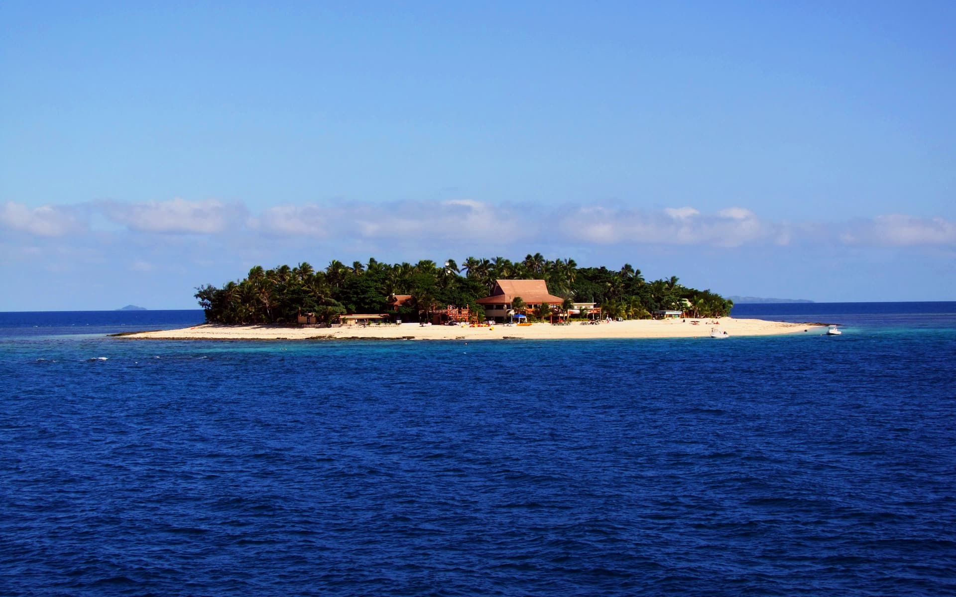 Beachcomber Island, a tiny coral cay ringed with white sand in the deep blue sea of the Mamanucas